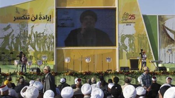 Hezbollah Commander Nasrallah speaks on screen in Beqaa, Lebanon (AFP / File)