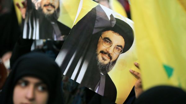 Hezbollah leader Hassan Nasrallah is seen on posters during a rally in Beirut. (AFP/File)