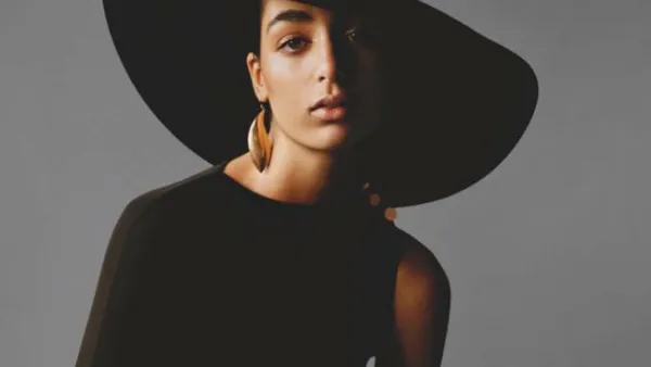Nora Attal turned heads in a black gown and accessorized her look with chunky gold jewelry (Source: noraattal - Instagram)