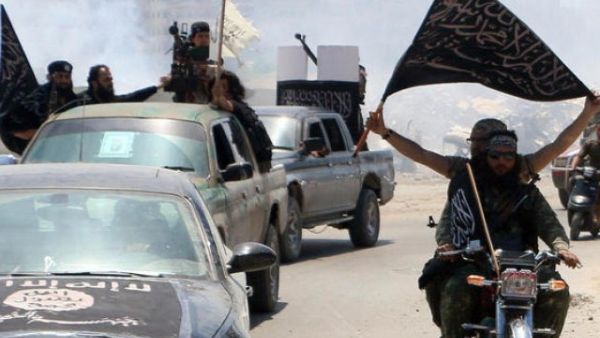 Fighters from al-Qaeda's Syrian affiliate al-Nusra Front drive in the Syrian city of Aleppo flying flags. (AFP/File)