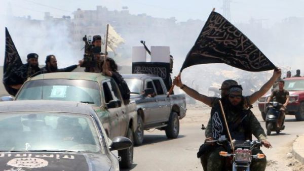 Fighters from Al-Qaeda's Syrian affiliate al-Nusra Front drive in the northern Syrian city of Aleppo flying flags as they head to a frontline, on May 26, 2015. (AFP/Fadi al-Halabi)