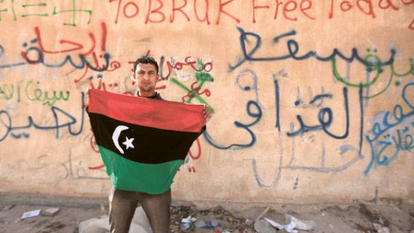An opposition protester hold a Libyan flag in the eastern city of Tobruk in 2011. (AFP/File)