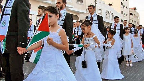 Photos of girls walking with the grooms of Gaza mass weddings are often mistaken as brides by the media. (Twitter)