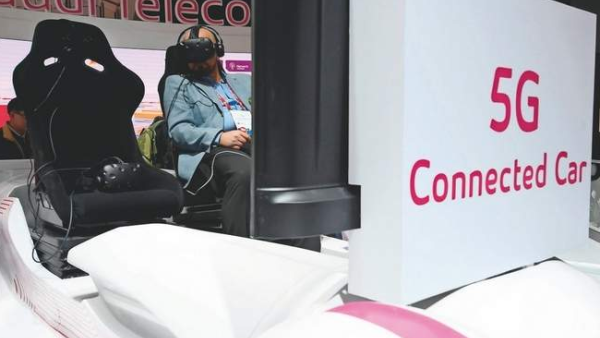 A man tries the Saudi Telecom virtual reality glasses on a 5G connected car at the MWC 2018 in Barcelona. (AFP)