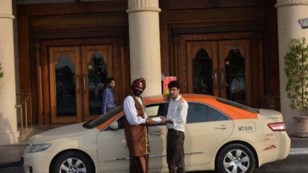 Arabian Courtyard Hotel Taxi driver receives iftar charity box Arabian Courtyard Hotel Taxi driver receives iftar charity box