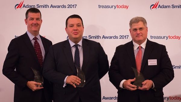 Adam Boukadida, Etihad Aviation Group (EAG) Acting Group Treasurer, pictured centre, flanked by Roger Fleischman, of J.P. Morgan, left, and Michael Guralnick, of Citibank, with some of EAG’s Adam Smith awards. 