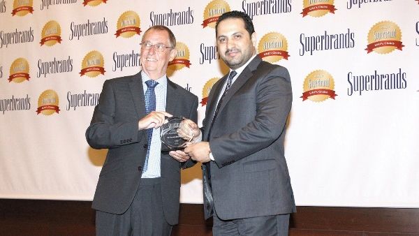 Ali Al Najjar, Assistant General Manager and Head of Operations Department at Al Ansari Exchange, receiving the Superbrand trophy at the gala night of the prestigious Superbrands Tribute Event