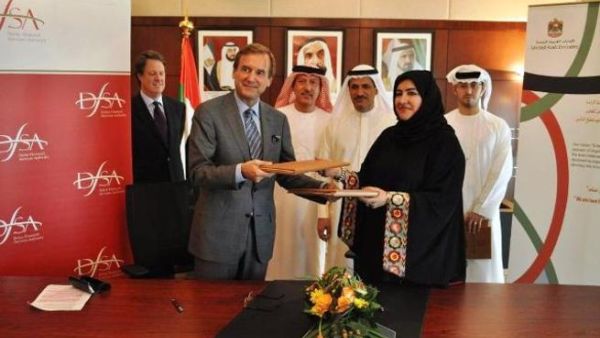 Paul Koster, Chief Executive of the DFSA, and  Fatima Mohammed Ishaq Al-Awadi, Deputy Director-General of the IA during the signing