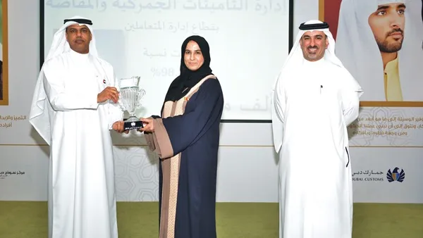 مدير جمارك دبي يقدم كأس الرضا الوظيفي إلى غنيمة إبراهيم أحمد مدير إدارة التأمينات الجمركية في فئة أفضل إدارة حققت أعلى مستوى رضا وظيفي للعام 2015