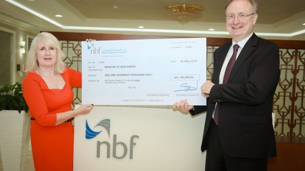 Vince Cook awarding 100,000 AED cheque to Mission to Seafarers.