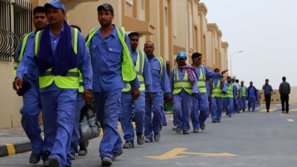 Foreign laborers walk home after working on al-Wakrah football stadium. (AFP/Marwan Naamani)