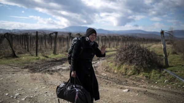A migrant woman crosses the Greek-Macedonian border near the town of Gevgelija, on February 14, 2016. (AFP/Robert Atanasovski)