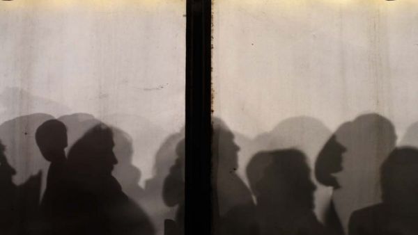 Asylum seekers line up at a government office in Berlin in January 2016.  (AFP/Tobias Shwarz)