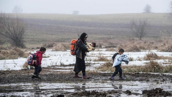 Migrants and refugees walk after crossing the Macedonian border into Serbia. (AFP/File) Migrants and refugees walk after crossing the Macedonian border into Serbia. (AFP/File)