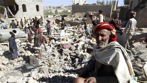 A man sits on the rubble as people search for survivors in houses destroyed by Saudi airstrikes on a residential area in Sanaa, May 1, 2015. (AFP/File)