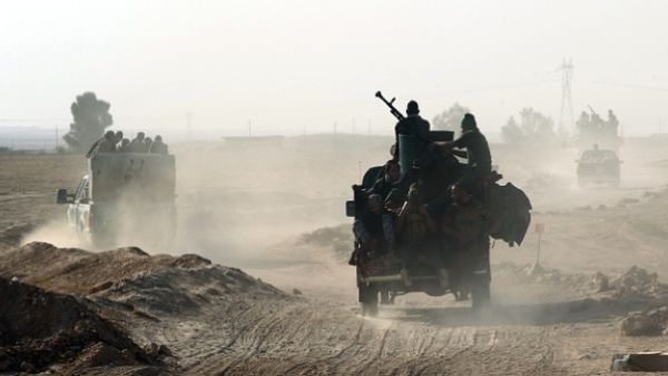 Shia fighters from the Popular Mobilization Forces arrive south of Mosul as part of the largest military operation in Iraq in years. (AFP/File)