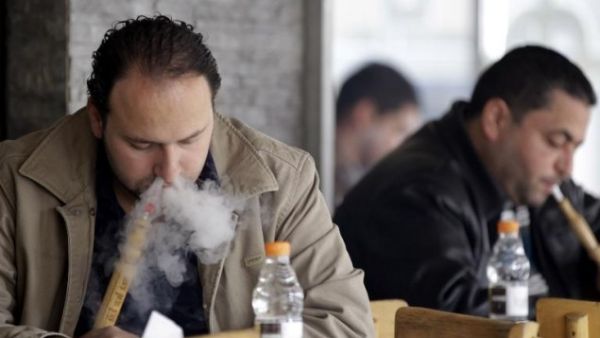 Men smoke water pipes, known as arghileh, at a cafe in Amman, Jordan.  (AFP/Khalil Mazraawi)
