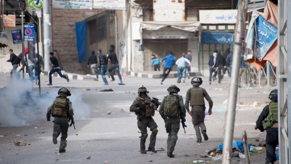  Israeli forces chase Palestinians (Shutterstock)