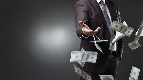 The video showed one person throwing Dh1,000 bank notes under his feet while being encouraged by the second. (Shutterstock)