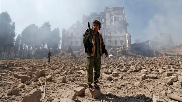 Houthi rebel fighters inspect the damage after a reported air strike carried out by the Saudi-led coalition targeted the presidential palace in the Yemeni capital Sanaa on Dec. 5. (AFP/ File)