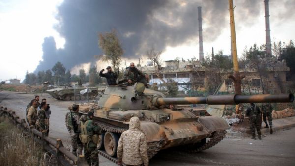Syrian government forces patrol near Aleppo's thermal power plant after they took control of the area on the eastern outskirts of Syria's northern embattled city from Islamic State (IS) group fighters on February 21, 2016. (AFP/George Ourfalian)