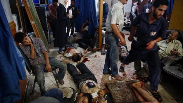Civilians in Douma receive medical treatment after regime airstrikes August 2015. (AFP/File)