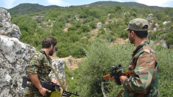 Syrian pro-government forces patrol an area in Sahl al-Ghab, in Hama province, on June 7, 2015. (AFP/File)