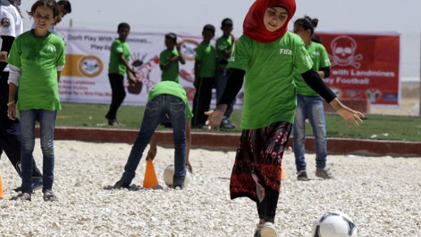 Syrian children play a football match in Jordan's Zaatari refugee camp on July 6, 2013.  (AFP/Khalil Mazraawi)
