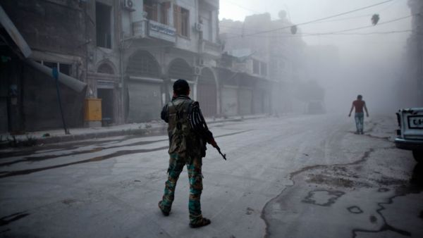 A Syrian rebel stands in the street in Aleppo. (AFP/Ahmed Deeb)