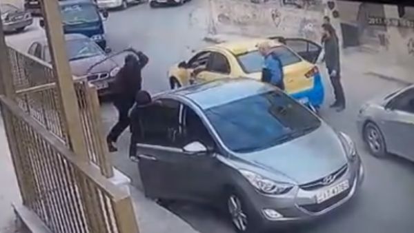 The man is seen taking a sword out of his trunk and striking the taxi driver’s arm with it before being pushed away by bystanders and a woman who was with him in the vehicle (Facebook)