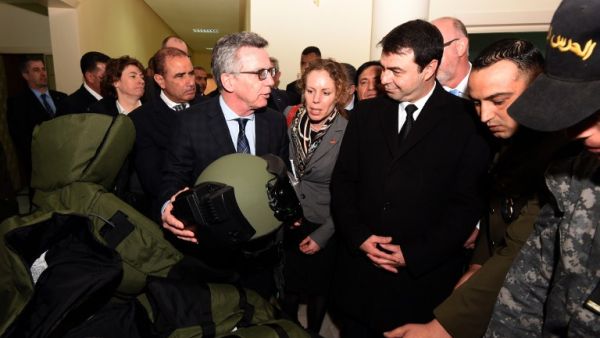 German Interior Minister Thomas de Maiziere and his Tunisian counterpart Hedi Majdoub inspect equipment, offered by Germany, at a national guard barracks on March 1, 2016 in Tunis.  (AFP/Fethi Belaid)