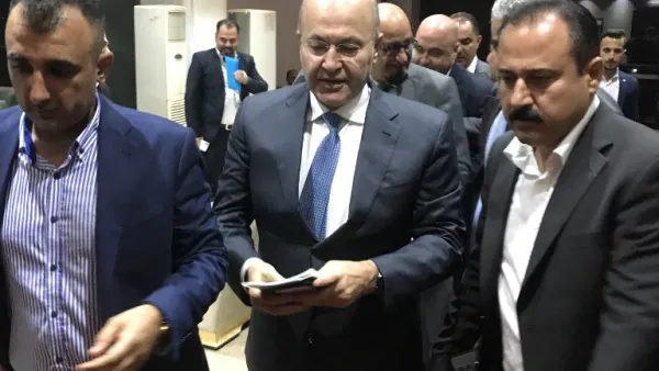 Newly elected Iraqi President Kurdish Barham Saleh (C) walks at the parliament in Baghdad on October 2, 2018. Karim AMMAR / AFP