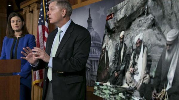 US Senator Kelly Ayotte talks about a photo of Sulaiman Abu Ghaith (L) during a press conference on Capitol Hill in Washington, DC. (AFP PHOTO/Brendan SMIALOWSKI)