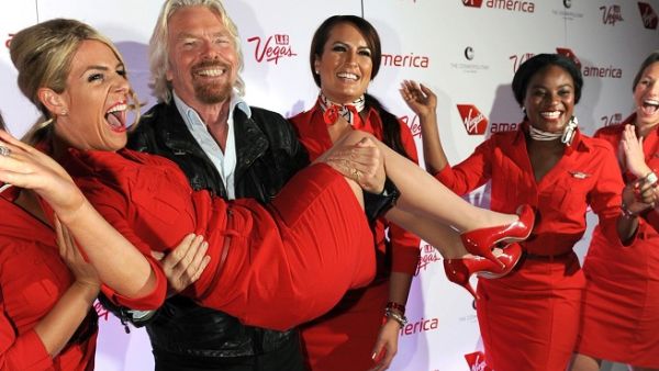 Virgin Group Founder Sir Richard Branson lifts a Virgin America staff member on April 22, 2013. (Virgin America/ Getty Images)