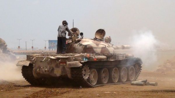 A Yemeni supporter of the separatist Southern movement stands on a tank firing during clashes with Houthis in Aden. (AFP/File)