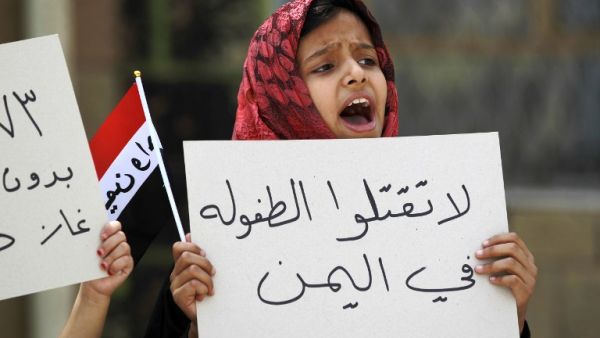 A Yemeni girl holds a placard during a protest in the capital Sanaa against the Saudi-led military operations, on June 6, 2015. The placard reads in Arabic: "Don't kill childhood in Yemen". (AFP/Mohammed Huwais)
