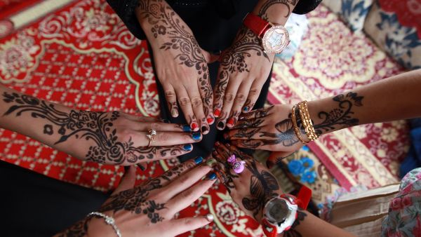 Yemeni girls show off their henna-decorated hands for Eid al-Fitr, the festival marking the end of Ramadan, July 29 2014.  (AFP/File)