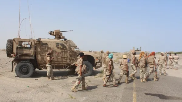 Yemeni Loyalist fighters walk through a town in southern Yemen after battling with Al-Qaeda militants on August 14, 2016. (AFP/Saleh al-Obeidi)