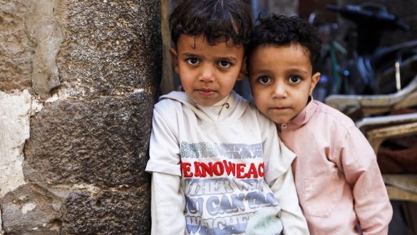 Two Yemeni children pose for a picture in a market in the capital, Sanaa, on January 24, 2017. (AFP/Mohammed Huwais)