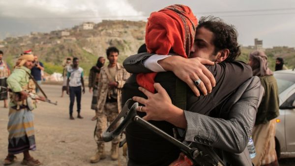 A Yemeni tribesman from the Popular Resistance Committees, supporting forces loyal to Yemen's Saudi-backed president, is greeted by a comrade after his release as part of a prisoner exchange with the Houthi rebels in the southwestern city of Taiz on June 1, 2016. (AFP/Ahmad al-Basha)