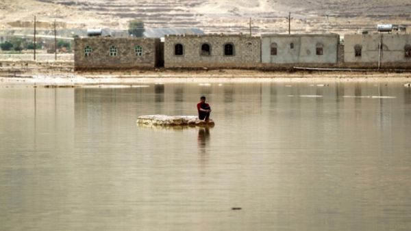 A man sits on a rock in a flooded street following heavy rain in the city of Amran, 50 kms north of Yemen's capital Sanaa on April 15, 2016. (AFP/Mohammed Huwais) A man sits on a rock in a flooded street following heavy rain in the city of Amran, 50 kms north of Yemen's capital Sanaa on April 15, 2016. (AFP/Mohammed Huwais)