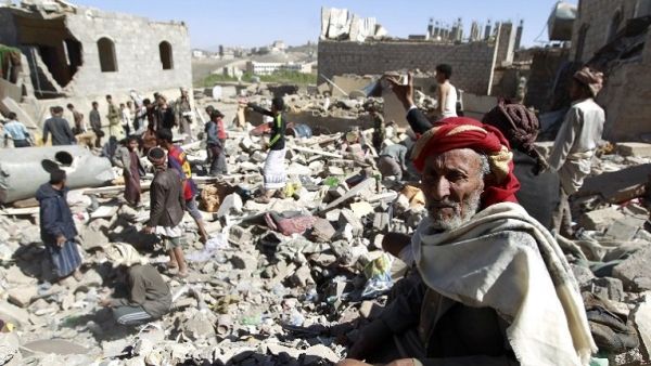 A Yemeni man sits on the rubble as people search for survivors in houses destroyed by a Saudi-led air strike on Yemen’s capital, Sanaa, on May 1, 2015. (Mohammed Huwais/ AFP)