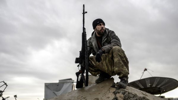 A member of the YPG, the military wing of the Kurdish PYD party, sits on rubble in Syria. (AFP/File) A member of the YPG, the military wing of the Kurdish PYD party, sits on rubble in Syria. (AFP/File)