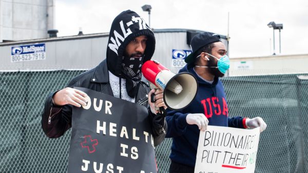 Former Amazon employee Chris Smalls and Amazon employee Jordan Flower at a may day protest in front of the Amazon JFK8 Distribution Center. (Shutterstock) Germany: Amazon Workers Go on Strike Over COVID-19