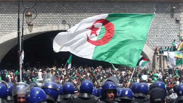 Algerian protesters wave a giant national flag (AFP)