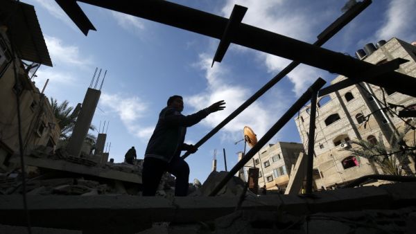 A Palestinian man checks the damaged to a structure hit by Israeli air strikes on Rafah in the southern Gaza strip  (AFP)