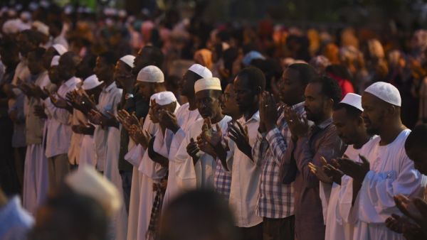 Supporters of Sudanese Islamist movements perform the Maghrib (sunset) prayer ahead of Iftar (AFP)