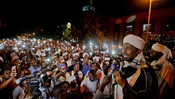 Sudanese hardline cleric Mohamed Ali Jazuli speaks as supporters of Islamist movements rally in front of the Presidential Palace in downtown Khartoum (AFP)