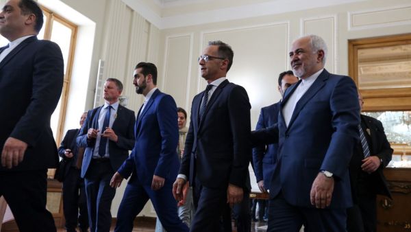 Iran's Foreign Minister Mohammad Javad Zarif (R) escorts his German counterpart Heiko Maas (C) after giving a joint press conference in the capital Tehran on June 10, 2019.  ATTA KENARE / AFP