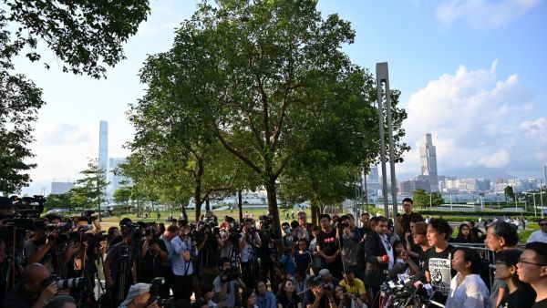 Civil Human Rights Front (CHRF) member Jimmy Sham (R) reacts during a press conference in Hong Kong on June 15, 2019 after Hong Kong Chief Executive Carrie Lam suspended a hugely divisive bill that would allow extraditions to China in a major climbdown after a week of unprecedented protests and political unrest.  HECTOR RETAMAL / AFP